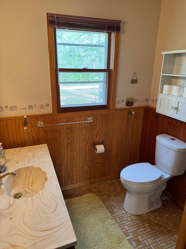 27721 Northwoods Dr, Laporte, MN 56461 - bathroom with toilet, wainscoting, wooden walls, and vanity