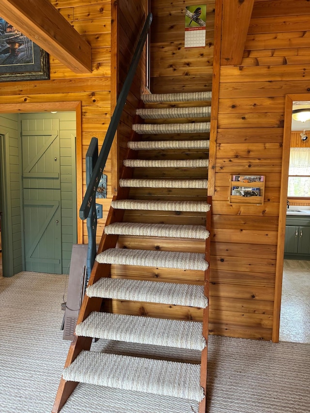 27721 Northwoods Dr, Laporte, MN 56461 - stairs with carpet, wooden walls, and beam ceiling