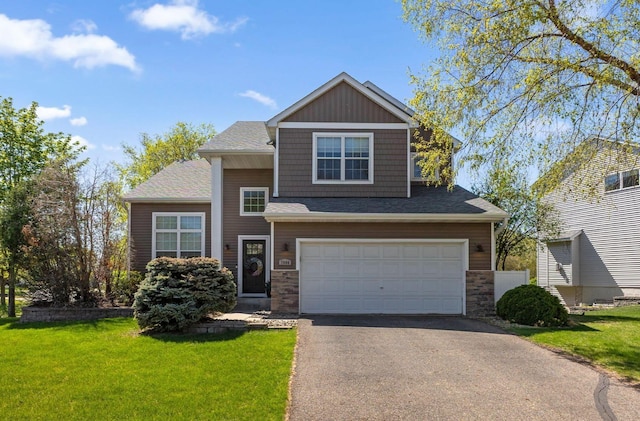 view of front facade featuring an attached garage, driveway, a front yard, stone siding, and roof with shingles