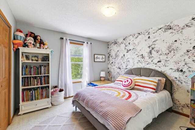 carpeted bedroom with a textured ceiling