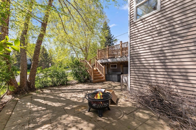 view of patio / terrace featuring a fire pit, stairway, and a wooden deck