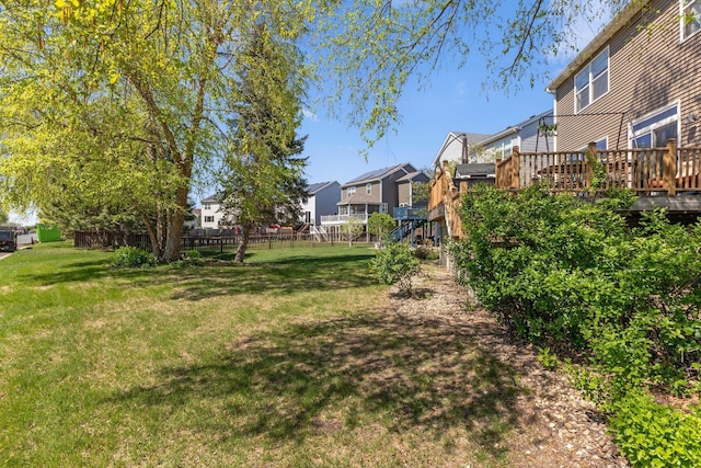 view of yard featuring a residential view and a wooden deck
