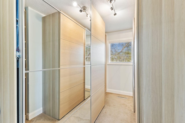 bathroom with a textured ceiling and baseboards