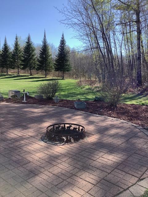 19323 Wendigo Park Rd, Harris Twp, MN 55744 - view of patio with an outdoor fire pit