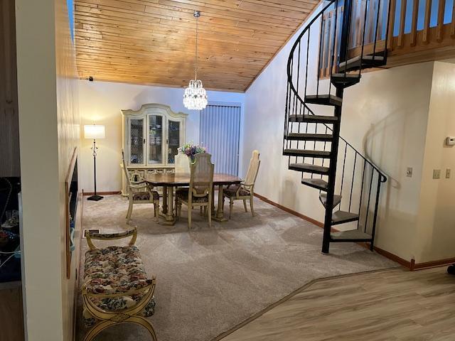 19323 Wendigo Park Rd, Harris Twp, MN 55744 - dining space featuring wooden ceiling, stairway, baseboards, a chandelier, and lofted ceiling