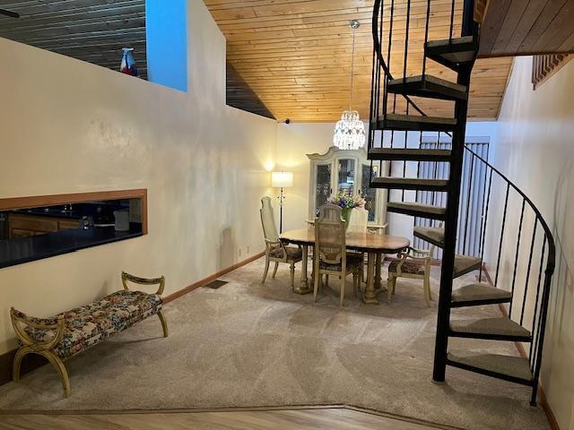 19323 Wendigo Park Rd, Harris Twp, MN 55744 - dining space with stairs, wood ceiling, baseboards, a chandelier, and lofted ceiling