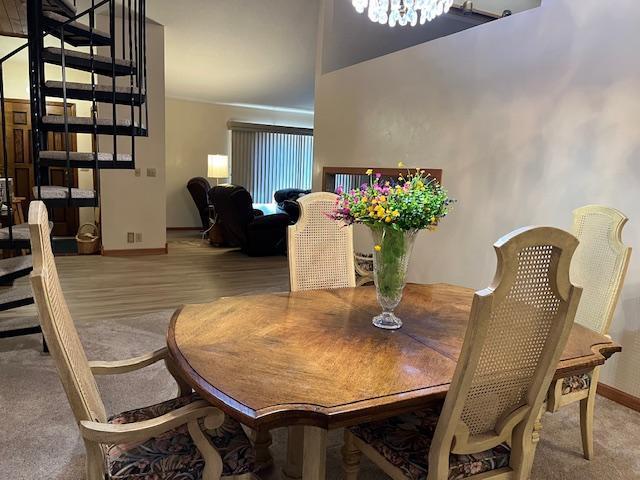 19323 Wendigo Park Rd, Harris Twp, MN 55744 - dining area with baseboards, a chandelier, and wood finished floors