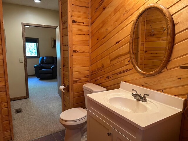 19323 Wendigo Park Rd, Harris Twp, MN 55744 - bathroom featuring vanity, toilet, recessed lighting, and wooden walls