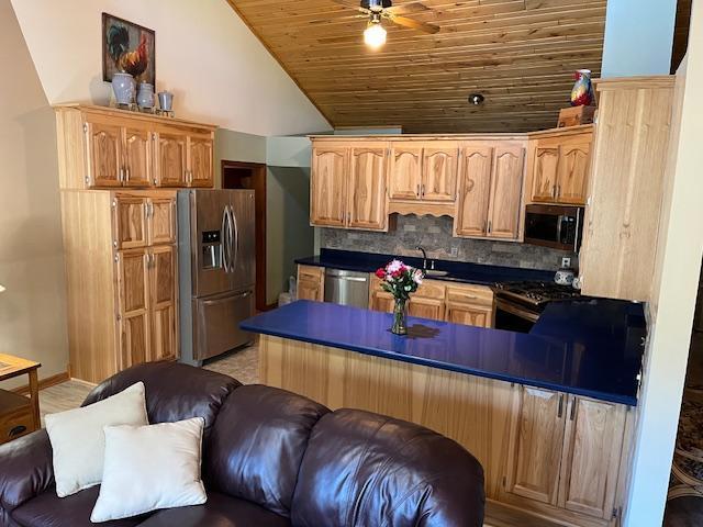 19323 Wendigo Park Rd, Harris Twp, MN 55744 - kitchen with stainless steel appliances, ceiling fan, dark countertops, wood ceiling, and backsplash
