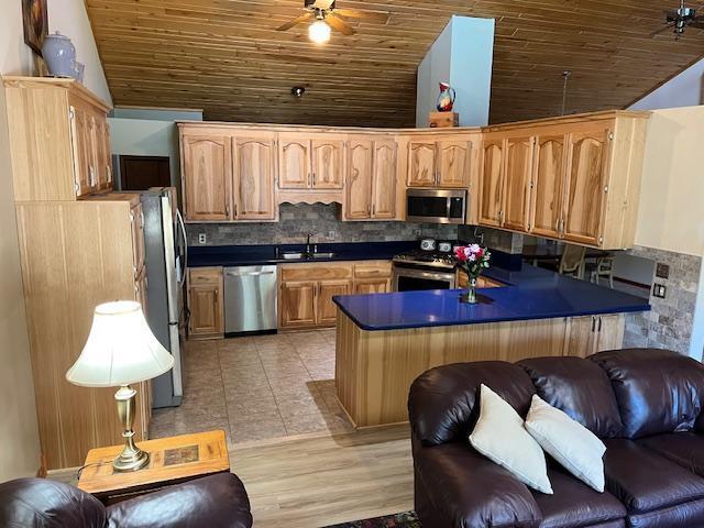 19323 Wendigo Park Rd, Harris Twp, MN 55744 - kitchen featuring appliances with stainless steel finishes, vaulted ceiling, a sink, wood ceiling, and dark countertops