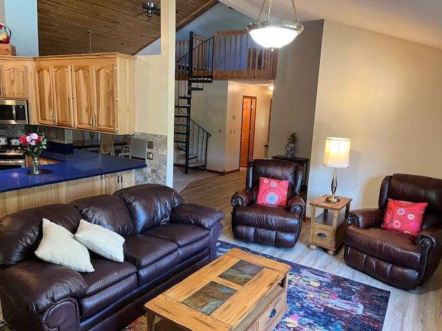 19323 Wendigo Park Rd, Harris Twp, MN 55744 - living room featuring wood finished floors, stairway, high vaulted ceiling, a ceiling fan, and wooden ceiling