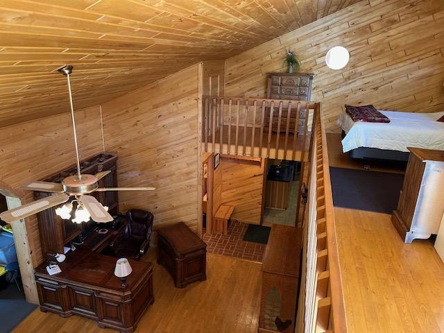 19323 Wendigo Park Rd, Harris Twp, MN 55744 - bedroom featuring wood walls, wooden ceiling, and wood finished floors