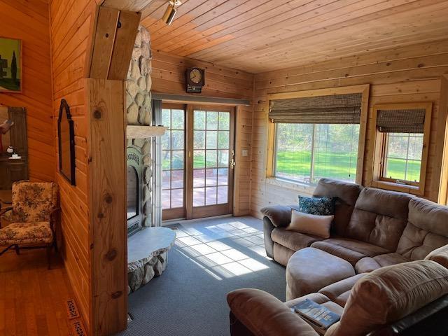 19323 Wendigo Park Rd, Harris Twp, MN 55744 - living area with wood walls, healthy amount of natural light, and wood ceiling