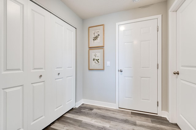 interior space featuring light wood-style floors and baseboards