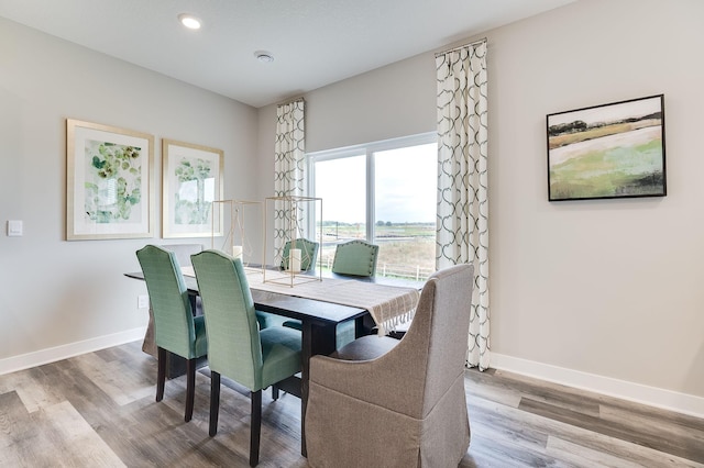 dining room with wood finished floors, baseboards, and recessed lighting