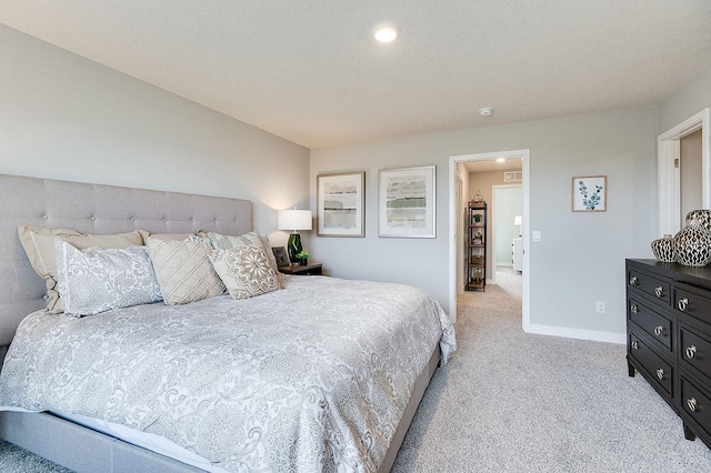bedroom featuring light carpet, baseboards, and recessed lighting