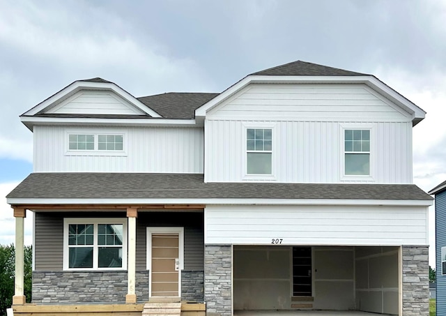 207 Snowdrop Trl, Waconia, MN 55387 - view of front of property with a garage, stone siding, a shingled roof, driveway, and entry steps