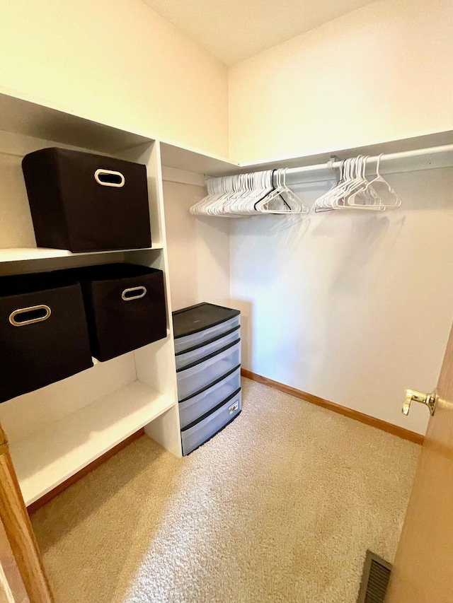 walk in closet with carpet