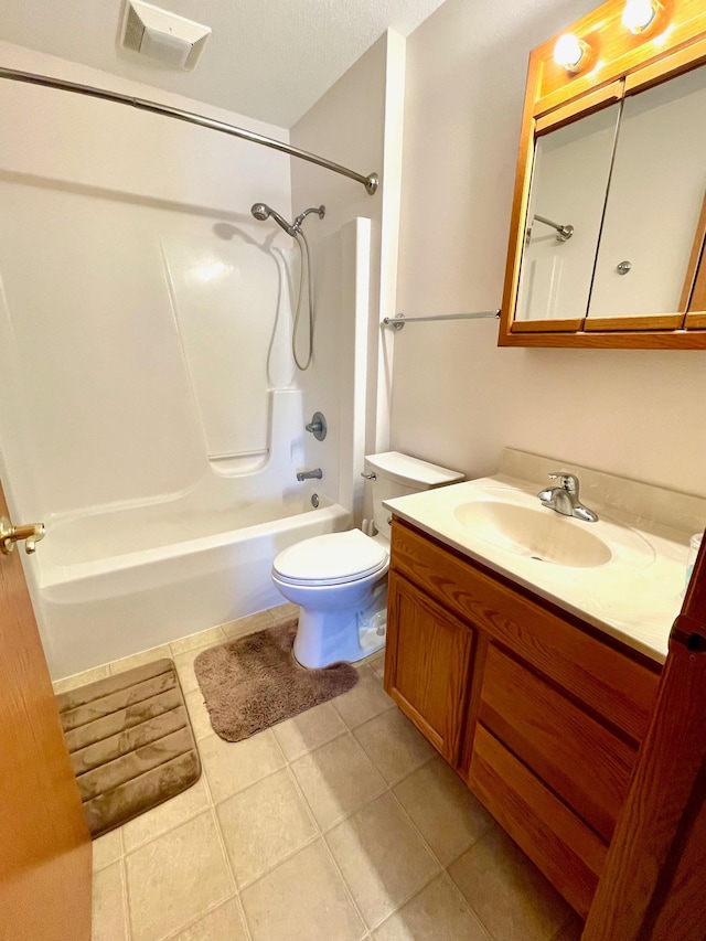 bathroom featuring tile patterned floors, vanity, toilet, and washtub / shower combination