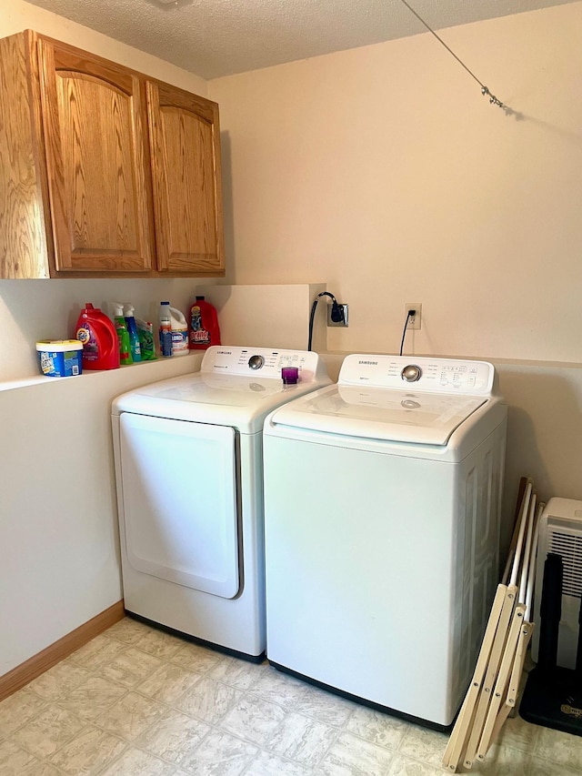 laundry area with washer and clothes dryer and cabinet space