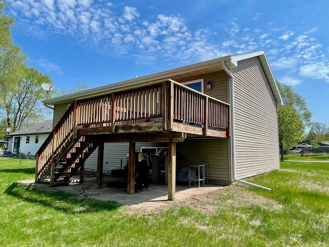 rear view of house featuring a deck, stairway, a yard, and a patio