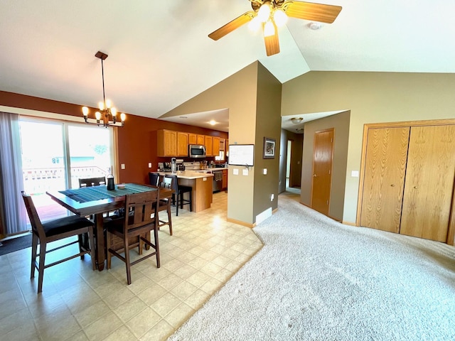 dining area featuring a chandelier, a ceiling fan, baseboards, and high vaulted ceiling