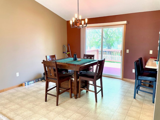 dining area with a chandelier, baseboards, and vaulted ceiling