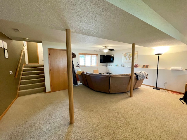 living room with carpet floors, baseboards, a textured ceiling, and stairs