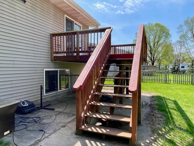 view of playground featuring stairs, a wooden deck, and a patio