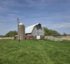 31190 181st, New Prague, MN 56071 - view of grassy yard featuring a barn and an outdoor structure