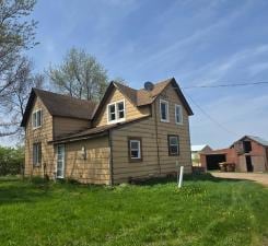 31190 181st, New Prague, MN 56071 - rear view of property with a lawn, driveway, and a garage