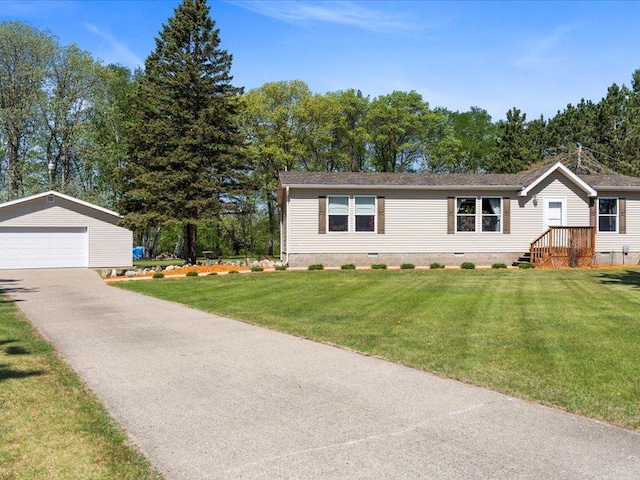 view of front facade with an outbuilding, crawl space, a garage, and a front lawn