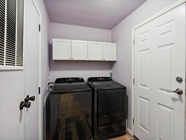laundry area with cabinet space and washer and dryer