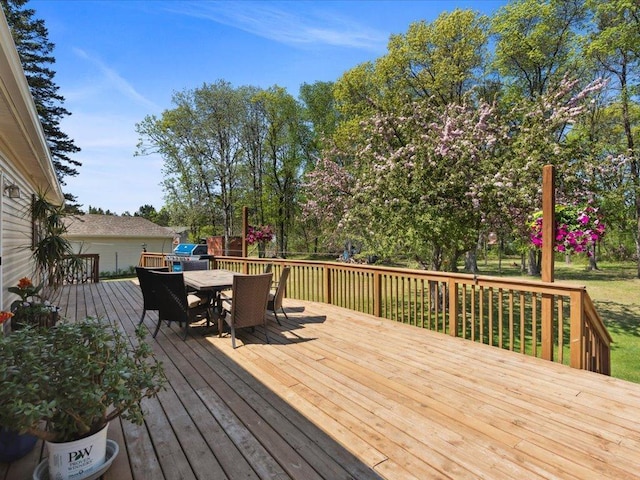 wooden terrace featuring outdoor dining area
