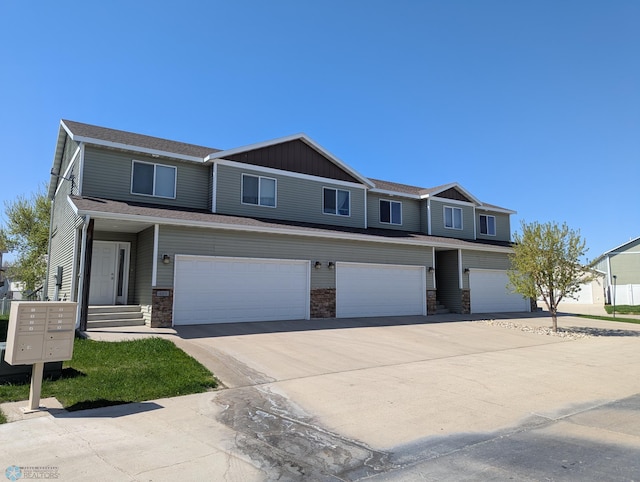 4213 51st St S 4203, 4209, Fargo, ND 58104 - multi unit property featuring an attached garage, stone siding, and concrete driveway
