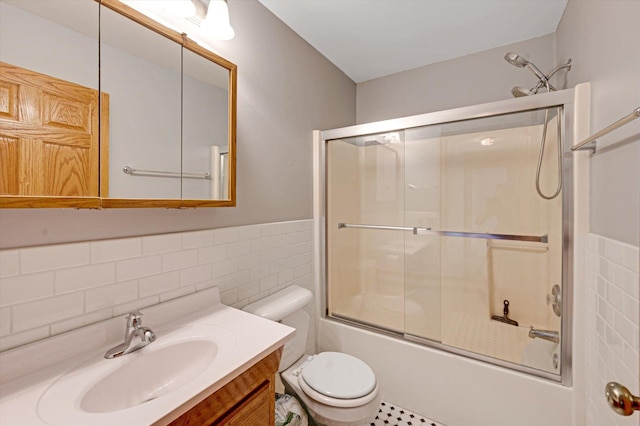 771 County Road B2 E, Little Canada, MN 55117 - bathroom featuring tile walls, toilet, shower / bath combination with glass door, vanity, and a wainscoted wall