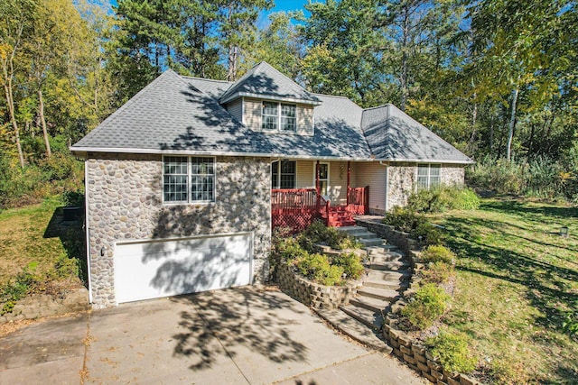 771 County Road B2 E, Little Canada, MN 55117 - view of front facade featuring driveway, stone siding, covered porch, and an attached garage