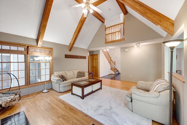 771 County Road B2 E, Little Canada, MN 55117 - living room featuring high vaulted ceiling, a ceiling fan, wood finished floors, stairs, and beamed ceiling