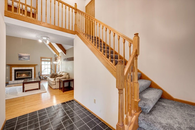 771 County Road B2 E, Little Canada, MN 55117 - stairway with a tiled fireplace, tile patterned flooring, and high vaulted ceiling