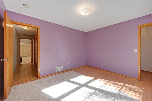 771 County Road B2 E, Little Canada, MN 55117 - empty room with a smoke detector and wood finished floors