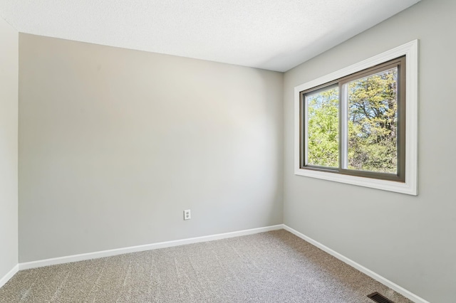 empty room with carpet floors and baseboards