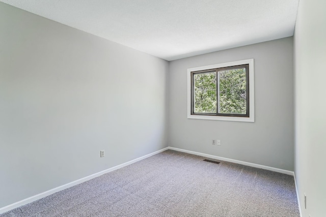 spare room with carpet floors and baseboards