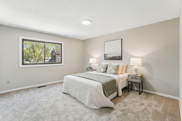 bedroom with carpet floors and baseboards
