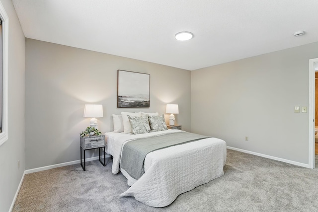 carpeted bedroom featuring baseboards