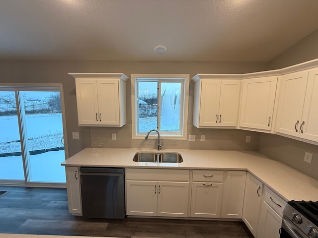kitchen with dishwasher, a sink, white cabinetry, and light countertops