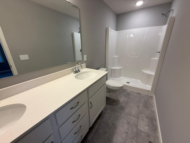 full bath featuring a shower stall, toilet, and double vanity