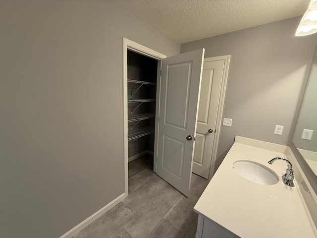 bathroom featuring vanity and a textured ceiling
