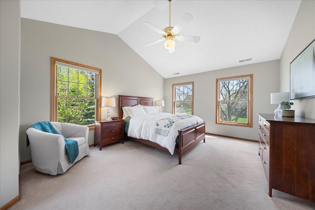 bedroom with lofted ceiling, light colored carpet, ceiling fan, and baseboards
