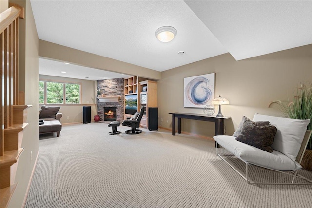 living area with baseboards, carpet floors, a fireplace, and built in features