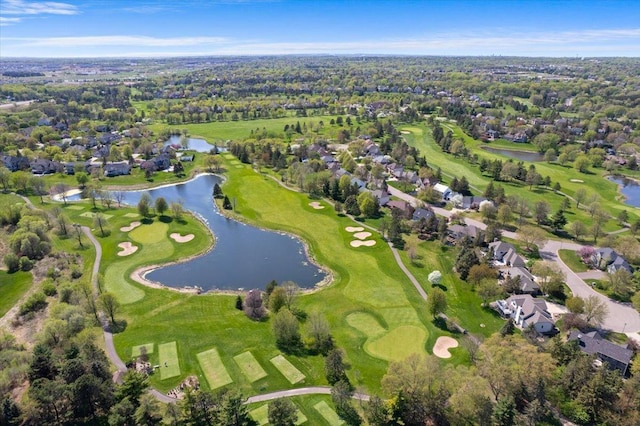 view of property location with a large body of water, nearby suburban area, and a golf club